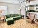 Inviting living room with a comfortable green sofa and hardwood floors, blending relaxation with timeless appeal at 2104 N Ball Ave, Muncie, IN 47304