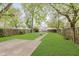 Large manicured backyard featuring healthy grass and a concrete patio at 625 N Grant Ave, Indianapolis, IN 46201
