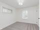 Bright bedroom featuring neutral walls, plush carpet, and natural light from two windows at 625 N Grant Ave, Indianapolis, IN 46201