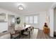 Bright dining room featuring a modern light fixture and view of the kitchen at 625 N Grant Ave, Indianapolis, IN 46201