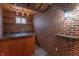 Finished basement showcasing brick walls, custom bar area, warm lighting, and unique barrel-themed decor at 14446 Chapelwood Ln, Fishers, IN 46037