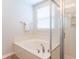 Modern bathroom with glass-enclosed shower and soaking tub, creating a luxurious and relaxing space at 14446 Chapelwood Ln, Fishers, IN 46037