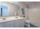 Well-lit bathroom with double vanity, bathtub and shower combo, toilet, and neutral-toned walls and flooring at 14446 Chapelwood Ln, Fishers, IN 46037