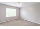 Well-lit bedroom featuring a large window and neutral carpet at 14446 Chapelwood Ln, Fishers, IN 46037