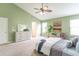 Bedroom with green walls, plush carpet, and a comfortable bed with neutral and blue accents at 14446 Chapelwood Ln, Fishers, IN 46037