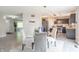 Open dining area with modern lighting and seamlessly connected to the kitchen at 14446 Chapelwood Ln, Fishers, IN 46037