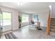 Bright entryway featuring wood floors, staircase, modern decor and a view of the front yard at 14446 Chapelwood Ln, Fishers, IN 46037