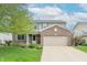 Charming two-story home with a brick facade, attached two-car garage, and well-maintained landscaping at 14446 Chapelwood Ln, Fishers, IN 46037