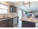 Open kitchen featuring granite counters, stainless steel appliances, and a seamless flow to the living area at 14446 Chapelwood Ln, Fishers, IN 46037