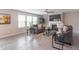 Comfortable living room with modern gray couches, fireplace, ceiling fan, and bright windows at 14446 Chapelwood Ln, Fishers, IN 46037