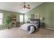 Bedroom with green walls, carpet, fan, decorative wall art, large windows and comfortable, inviting bed at 14446 Chapelwood Ln, Fishers, IN 46037