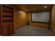 Home theater room complete with a projection screen and built-in bookcase at 14446 Chapelwood Ln, Fishers, IN 46037