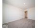 This bedroom offers neutral carpeting, white walls, and ample closet space at 1573 Hanover St, Danville, IN 46122