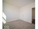 Bright bedroom with neutral carpet, white walls, and door, offers a serene retreat at 1573 Hanover St, Danville, IN 46122