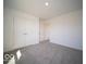 The bedroom has neutral carpeting, white walls, and a double door closet at 1573 Hanover St, Danville, IN 46122