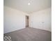 This bedroom has neutral carpeting, white walls, and a double door closet at 1573 Hanover St, Danville, IN 46122