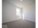 Cozy bedroom features neutral carpet and a bright window, creating a relaxing atmosphere at 1573 Hanover St, Danville, IN 46122