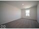Bright bedroom featuring neutral carpet, white walls, and a window for natural light and backyard views at 1573 Hanover St, Danville, IN 46122