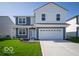 Charming two-story home features a spacious two-car garage and well-manicured lawn at 1573 Hanover St, Danville, IN 46122