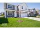 Two-story home with a two-car garage, green lawn and landscaping at 1573 Hanover St, Danville, IN 46122