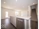 Modern kitchen features a central island with stainless steel dishwasher and backyard views at 1573 Hanover St, Danville, IN 46122