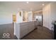 Kitchen offers stainless steel appliances, a center island, and neutral cabinets for a contemporary look at 1573 Hanover St, Danville, IN 46122