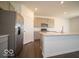 Stainless steel refrigerator complements the modern kitchen with gray cabinets and island with sink at 1573 Hanover St, Danville, IN 46122