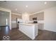 Modern kitchen boasts stainless steel appliances, gray cabinets, and a large island, perfect for entertaining at 1573 Hanover St, Danville, IN 46122