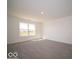 Bright living room featuring neutral carpet, white walls, and a large window for abundant natural light at 1573 Hanover St, Danville, IN 46122