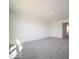 Bright living room featuring neutral carpet and white walls with a view towards a hallway at 1573 Hanover St, Danville, IN 46122