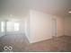 Upstairs living area featuring neutral carpeting, a window offering outside views, and a doorway at 1573 Hanover St, Danville, IN 46122