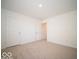 Bright bedroom featuring neutral carpet, white walls, and a double door closet at 1579 Hanover St, Danville, IN 46122