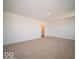 Carpeted primary bedroom showcasing a private ensuite bathroom entrance at 1579 Hanover St, Danville, IN 46122