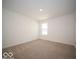 Cozy bedroom with neutral-toned carpet, white walls, and a bright window view at 1579 Hanover St, Danville, IN 46122
