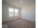Bright bedroom featuring a large window with neighborhood views and neutral carpet at 1579 Hanover St, Danville, IN 46122