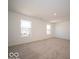 Sunlit bedroom featuring neutral walls and carpeting complemented by two well-placed windows at 1579 Hanover St, Danville, IN 46122