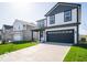 Charming two-story home with a well-maintained lawn and long driveway leading to an attached two-car garage at 1579 Hanover St, Danville, IN 46122