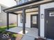 Welcoming front porch with dark pillars and trim, leading to the front door and attached garage at 1579 Hanover St, Danville, IN 46122