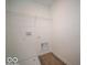 Practical laundry area equipped with wood-look floors, shelving, and hookups for washer and dryer at 1579 Hanover St, Danville, IN 46122