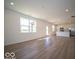 Open concept living room and kitchen with hardwood floors, white walls, and ample natural light at 1579 Hanover St, Danville, IN 46122