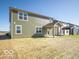 Backyard featuring an olive colored exterior with a covered porch at 1585 Hanover St, Danville, IN 46122