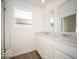 Bathroom with double sinks, marble countertops, and laminate floor at 1585 Hanover St, Danville, IN 46122