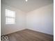 Cozy bedroom with hardwood floors and a large window at 1585 Hanover St, Danville, IN 46122