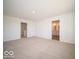 Bedroom with carpet, and a view into the bathroom with a double sink vanity at 1585 Hanover St, Danville, IN 46122