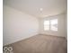 Bright bedroom with a window and plush carpeting at 1585 Hanover St, Danville, IN 46122