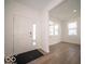 Bright entryway with hardwood floors and a view into the living area at 1585 Hanover St, Danville, IN 46122