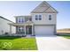 Charming two-story home featuring a two-car garage and covered porch at 1585 Hanover St, Danville, IN 46122