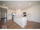 Modern kitchen features white cabinets, stainless steel appliances, and a large center island at 1585 Hanover St, Danville, IN 46122