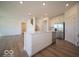 Open concept kitchen with large island, stainless appliances, and access to the staircase and living room at 1585 Hanover St, Danville, IN 46122