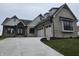 Beautiful gray brick home with a three-car garage and stylish architectural details on a landscaped lot at 16298 Grand Cypress Dr, Noblesville, IN 46060